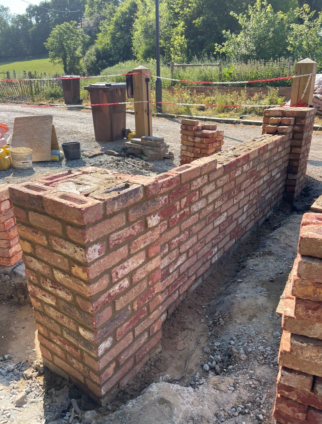 Boundary wall with brick piers alongside a driveway