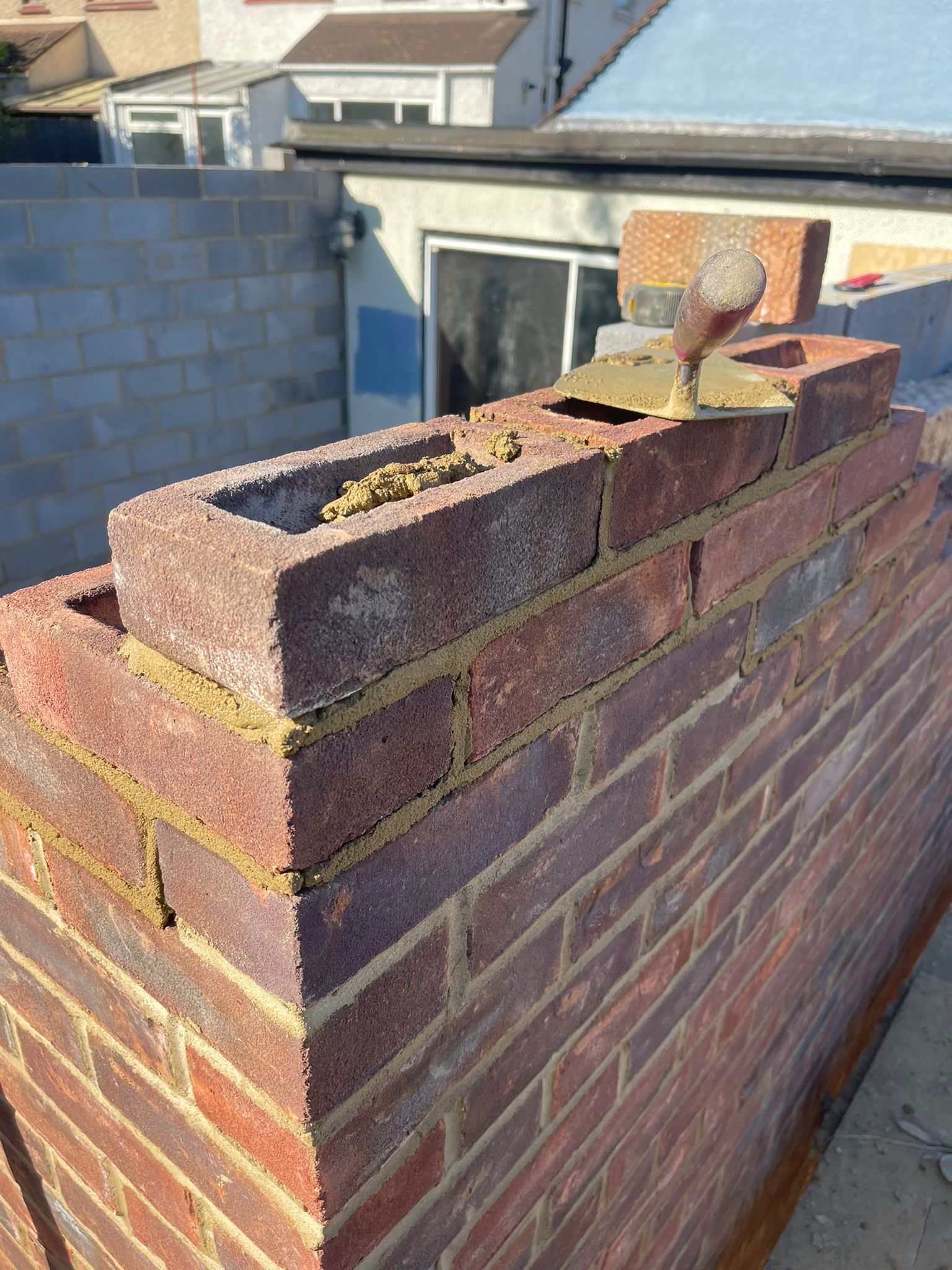 Bricklaying at height with trowel detail