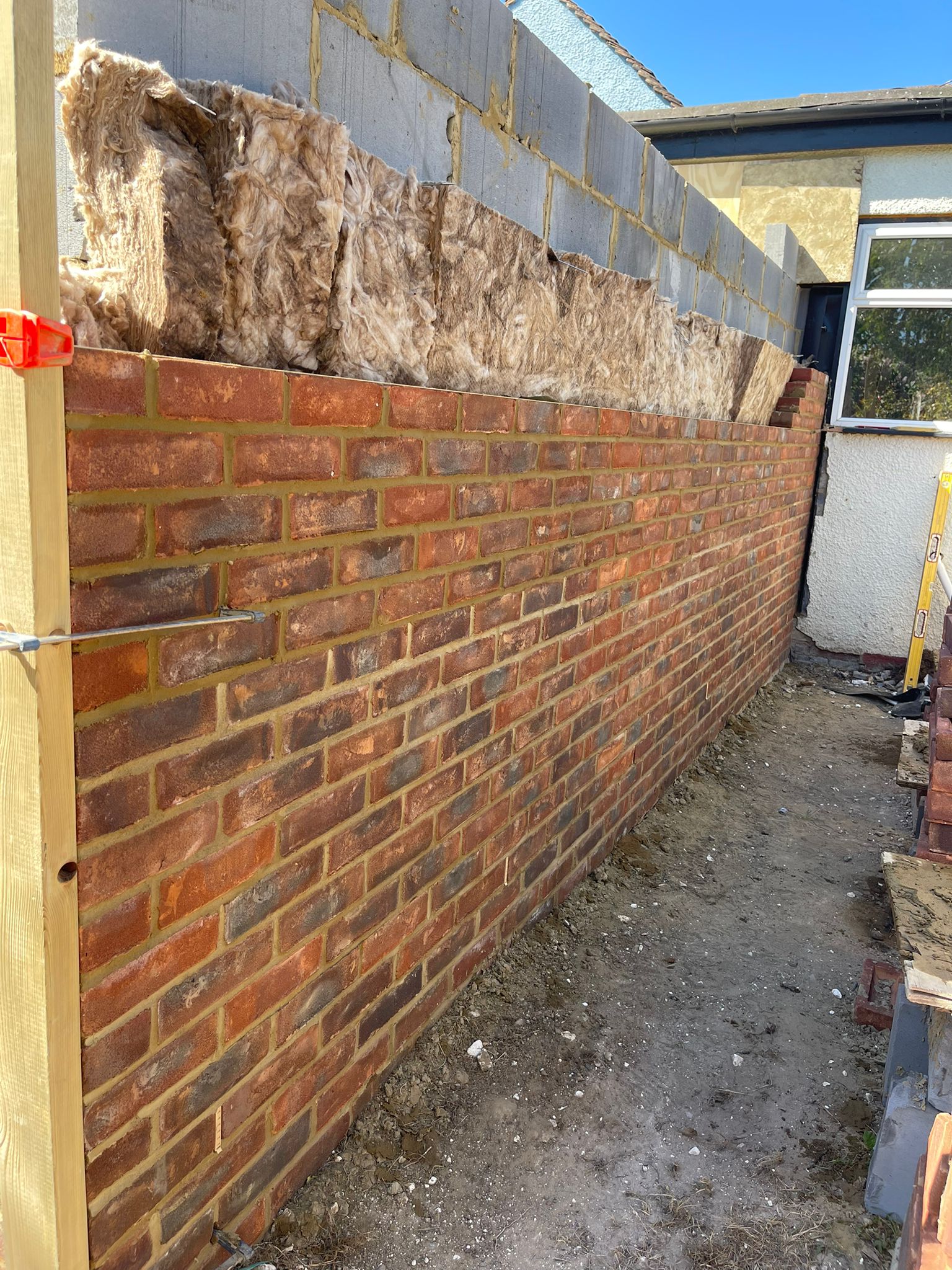 Extension wall with insulation batts and string line