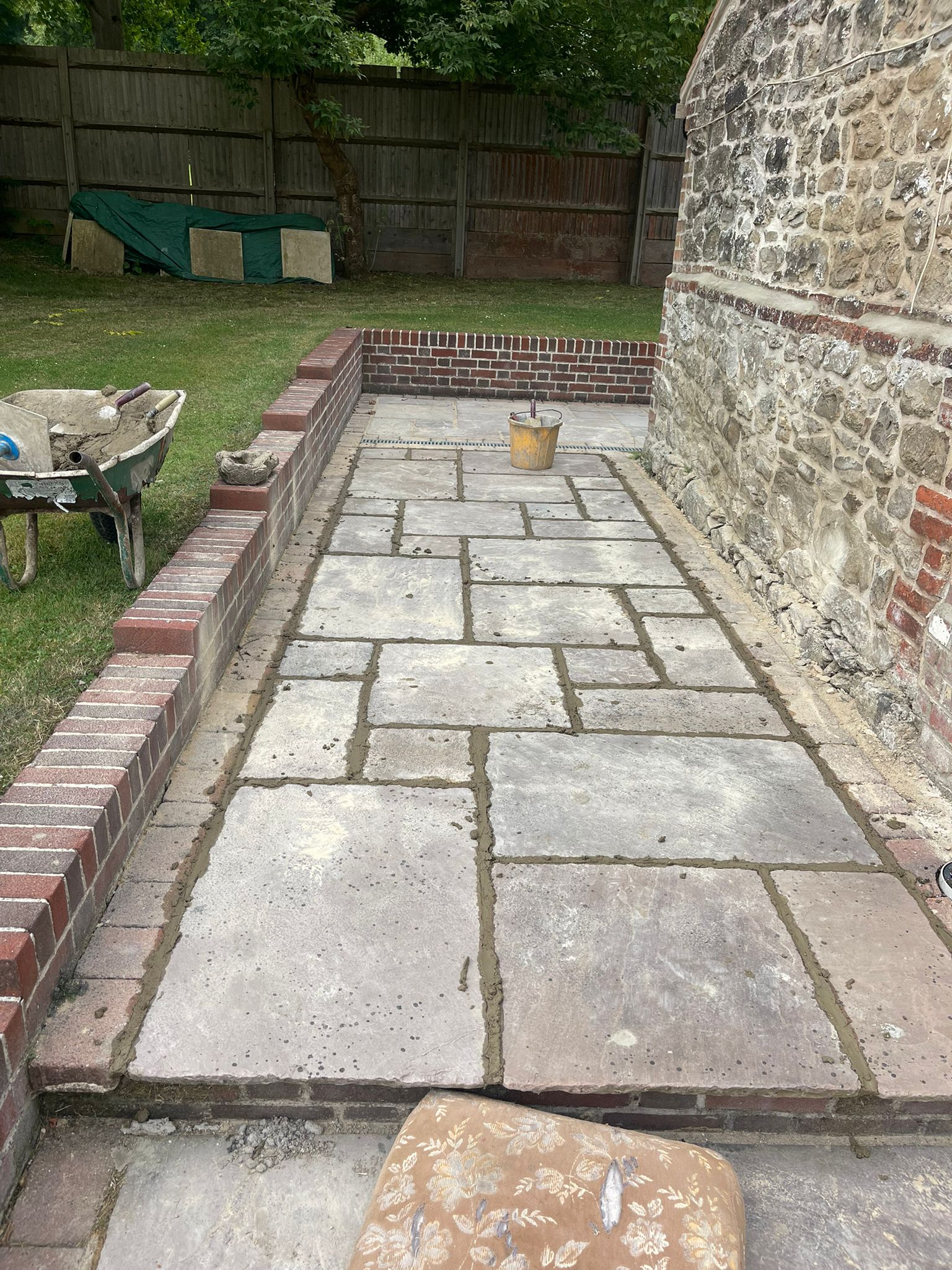 Flagstone patio being mortared at a heritage cottage