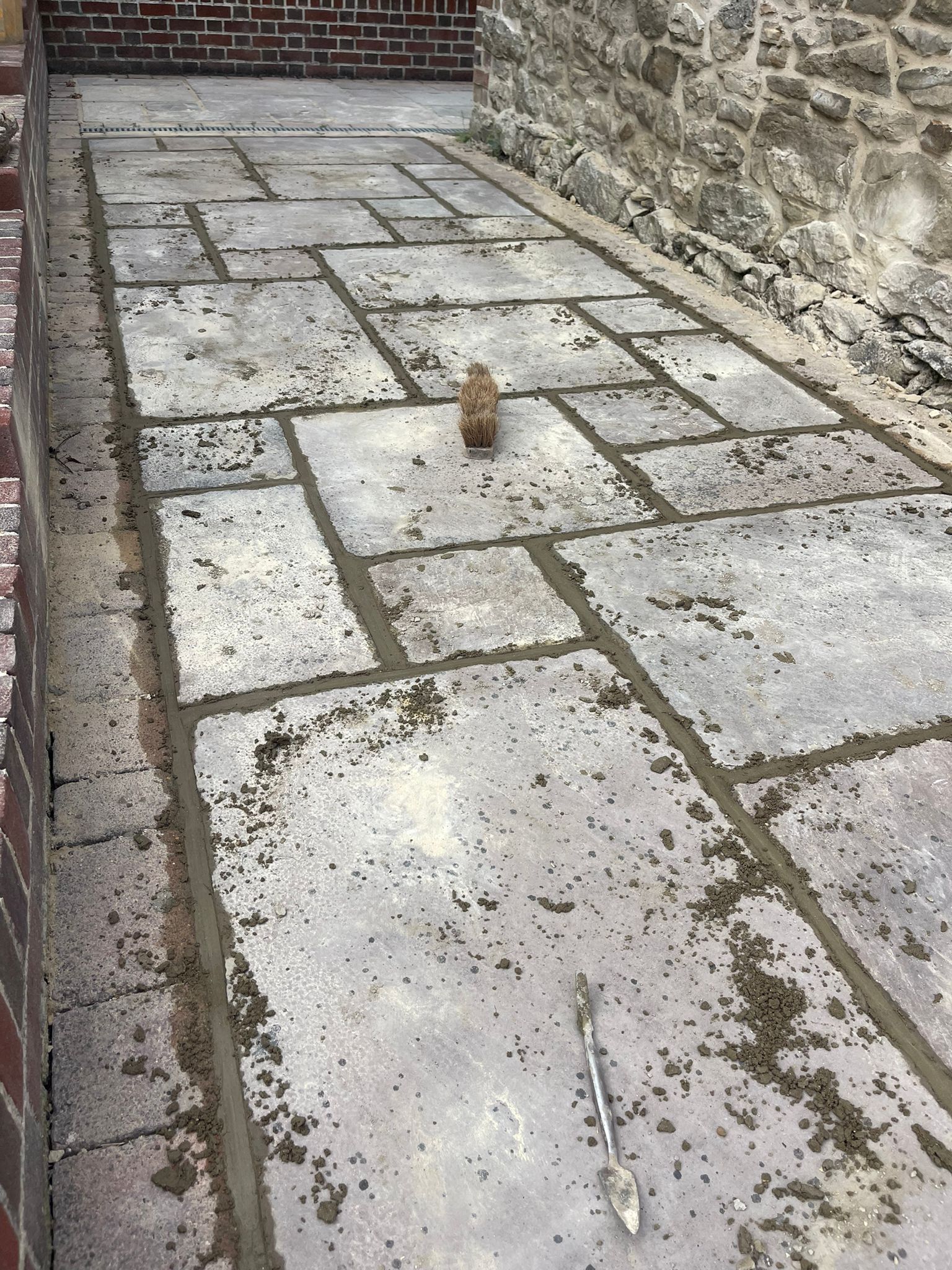 Flagstone patio at a stone cottage wide view