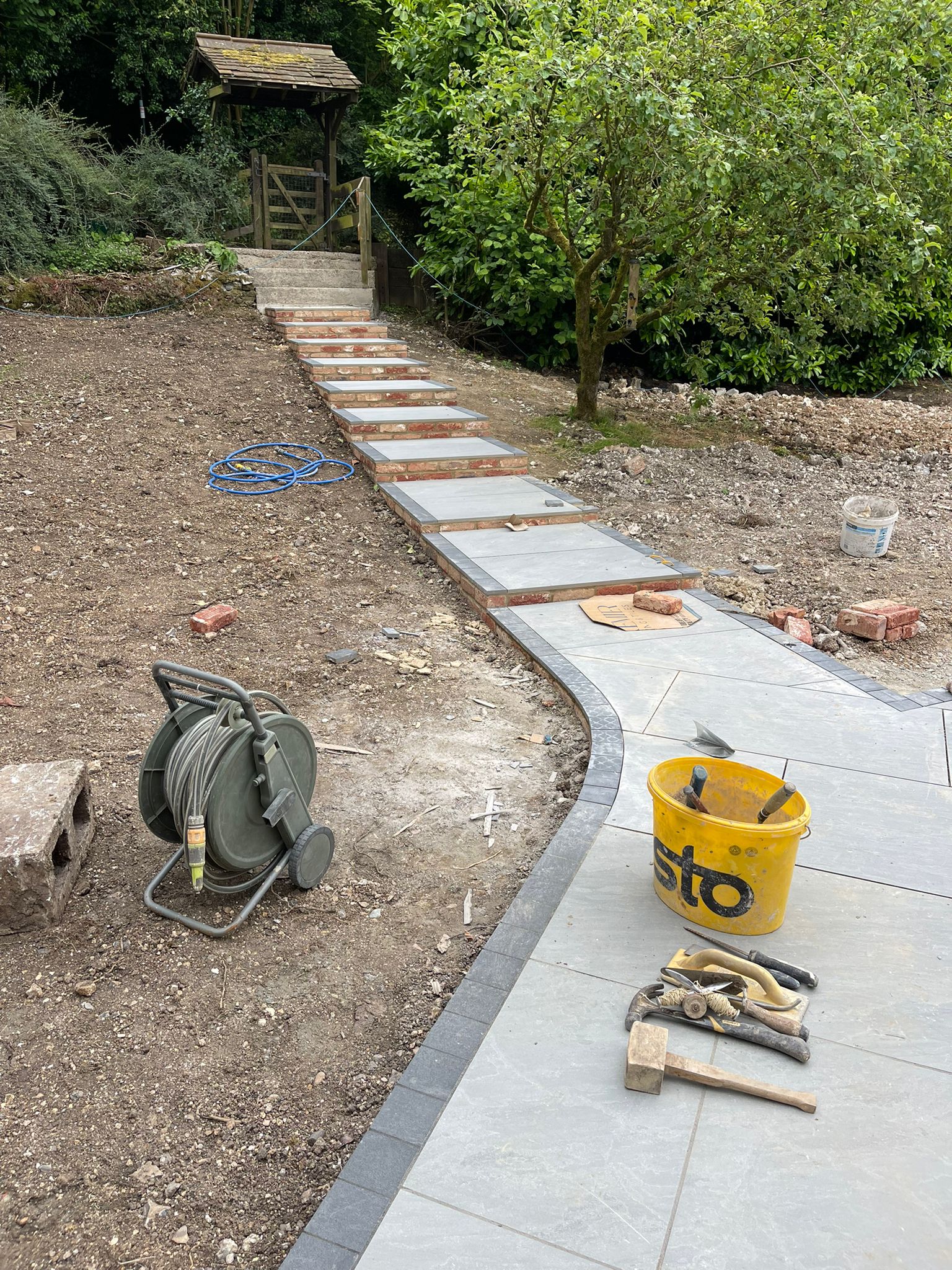 Garden steps with porcelain path up a slope