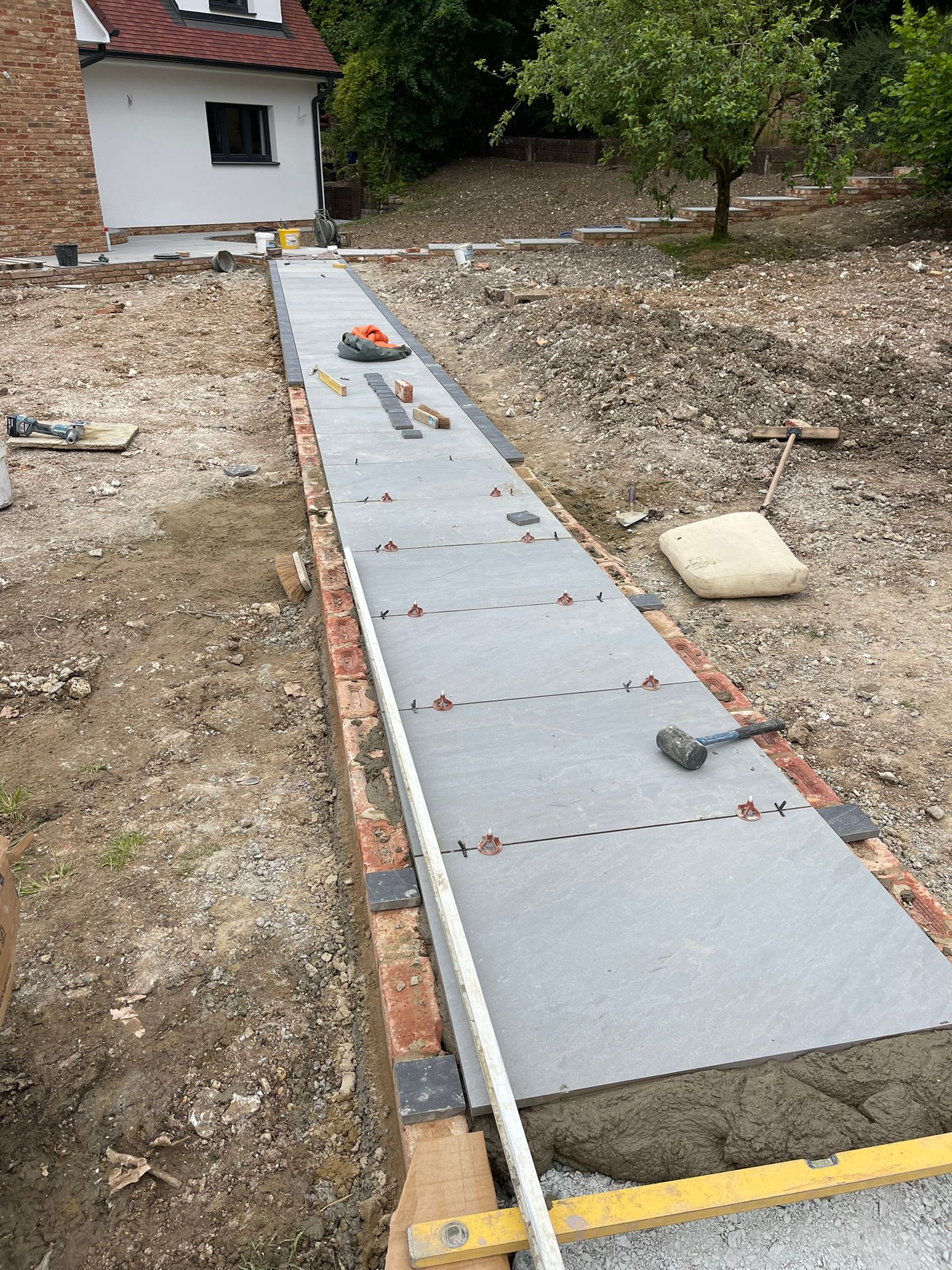 Porcelain driveway path with brick edging and tile spacers
