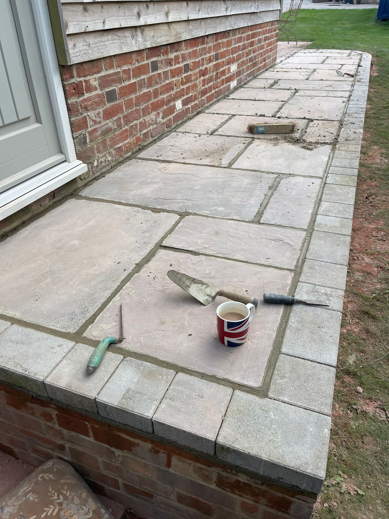 Raised natural stone patio with tools