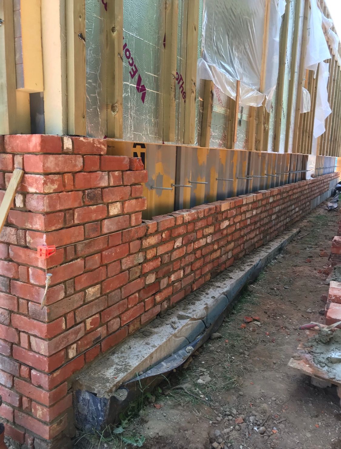 Long run of reclaimed brickwork with wall ties