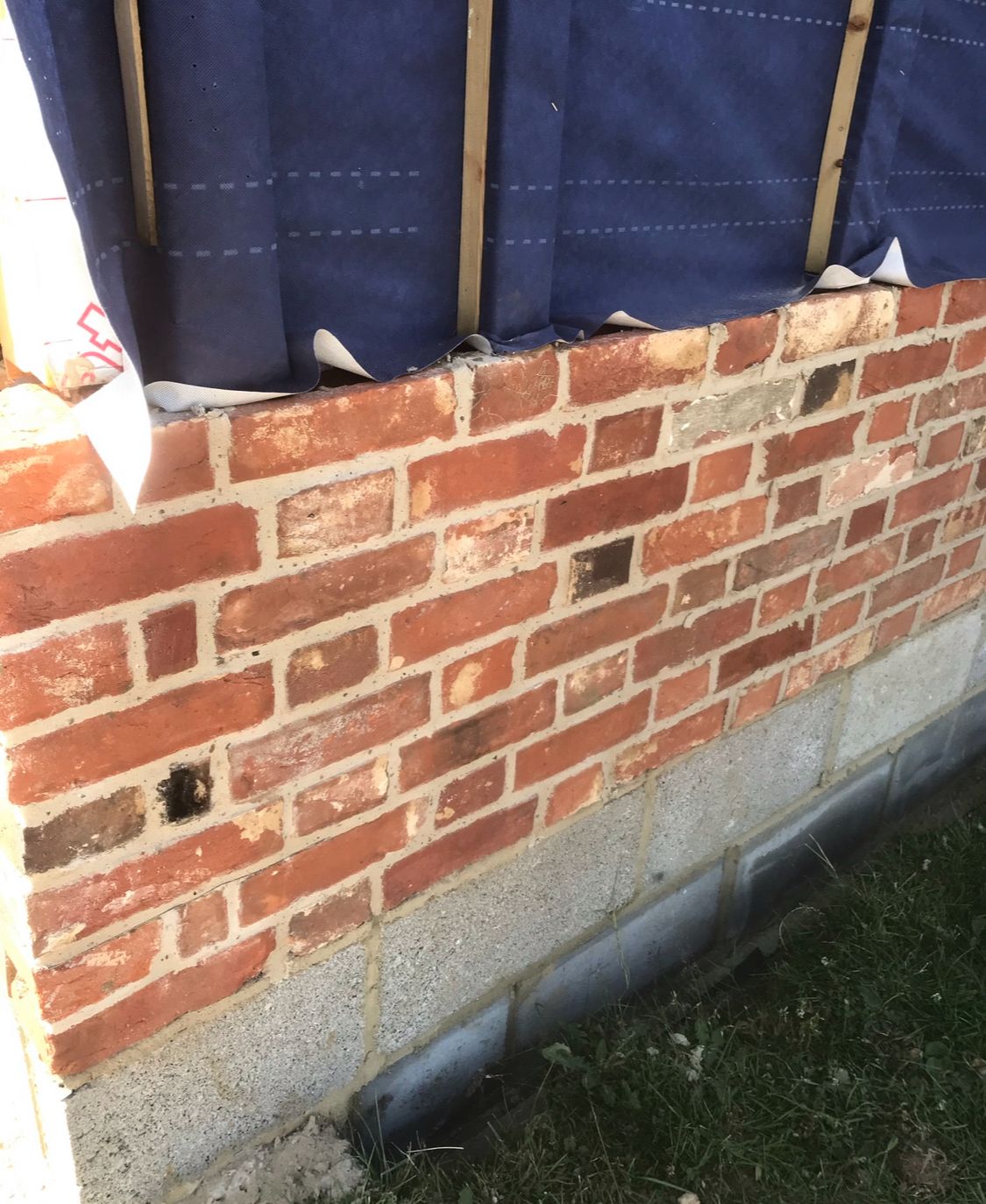 Reclaimed brick skin close-up showing handmade brick character