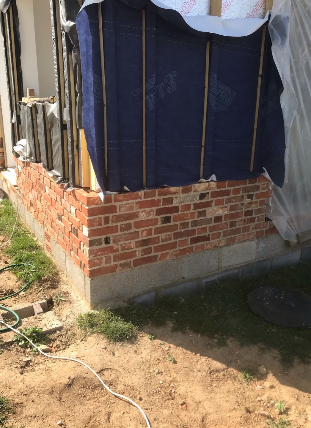 Reclaimed brick skin corner return on timber-frame new build