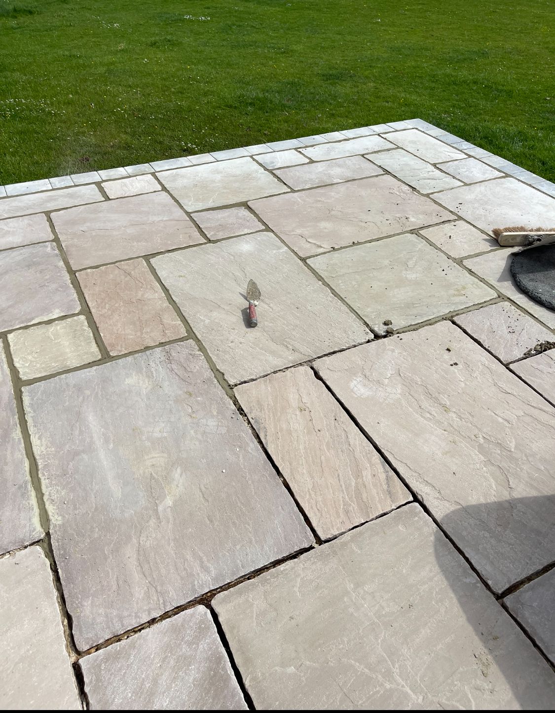 Natural sandstone patio being jointed