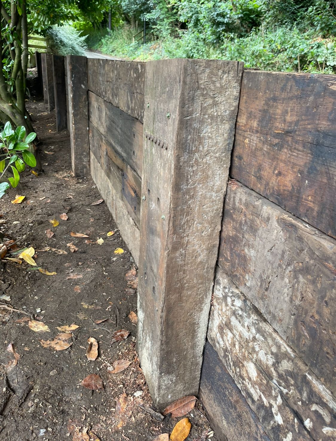 Oak railway sleeper retaining wall in garden