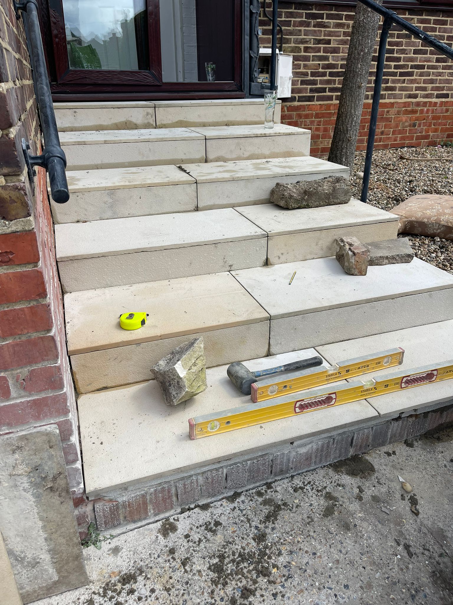 Stone steps in progress with spirit level
